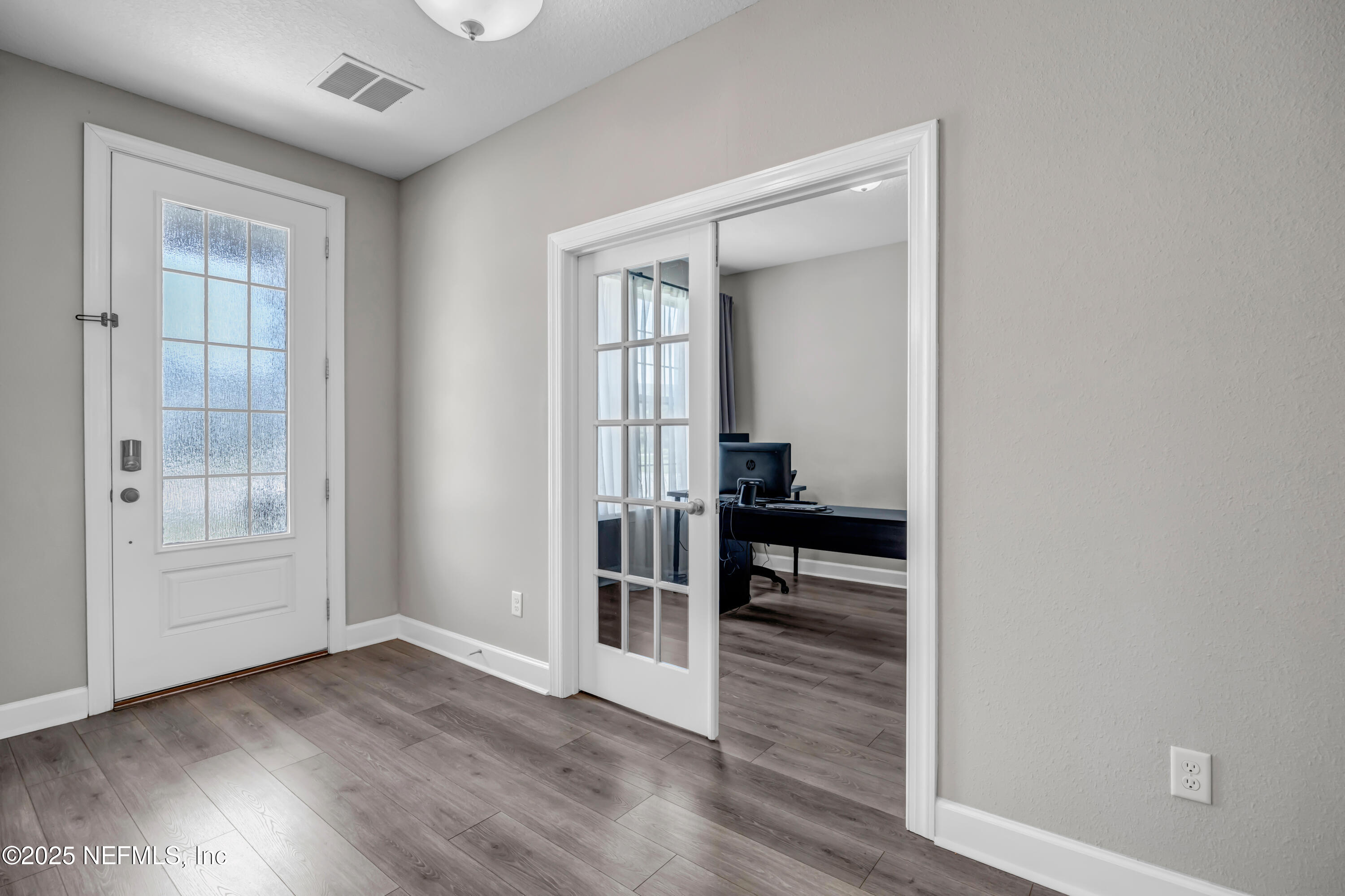 23 Catesby Lane St. Augustine, FL 32095 - Photo 2 of 31 wooden floor in an empty room with a window