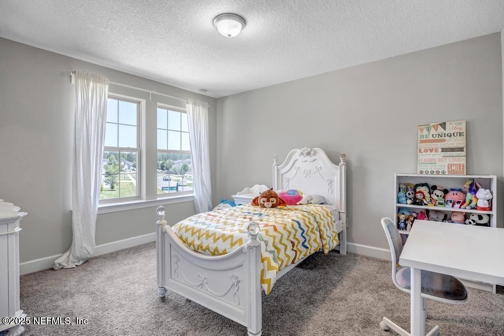 23 Catesby Lane St. Augustine, FL 32095 - Photo 22 of 31 a bedroom with a bed and a window