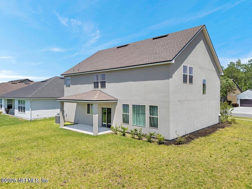 23 Catesby Lane St. Augustine, FL 32095 - Photo 25 of 31 a front view of a house with a yard