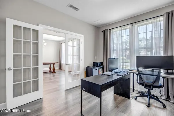 a view of a workspace with furniture and a window