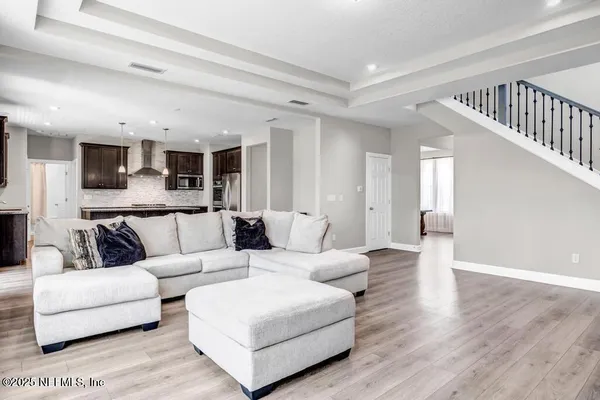 a living room with furniture and a wooden floor