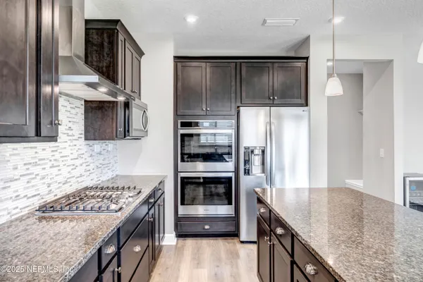 a kitchen with a refrigerator and a sink