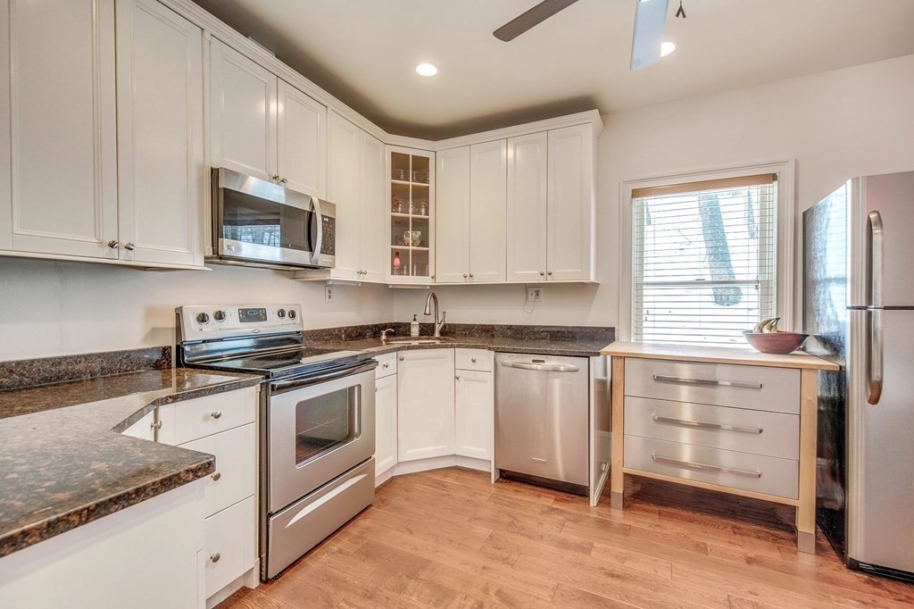 48 Valley Road Lexington, MA 02421 - Photo 3 of 15 a kitchen with stainless steel appliances granite countertop a stove a sink and a microwave