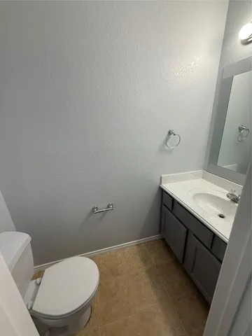 a bathroom with a sink mirror vanity and toilet