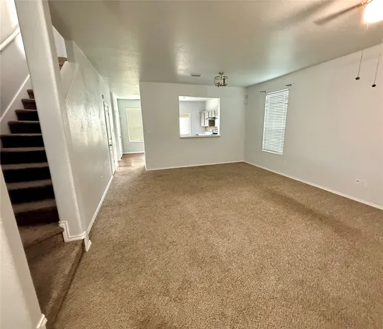 an empty room with windows and stairs