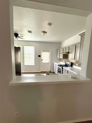 a view of kitchen cabinets and stainless steel appliances