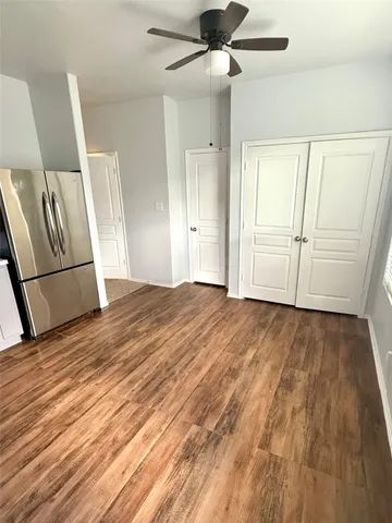 a view of empty room with wooden floor