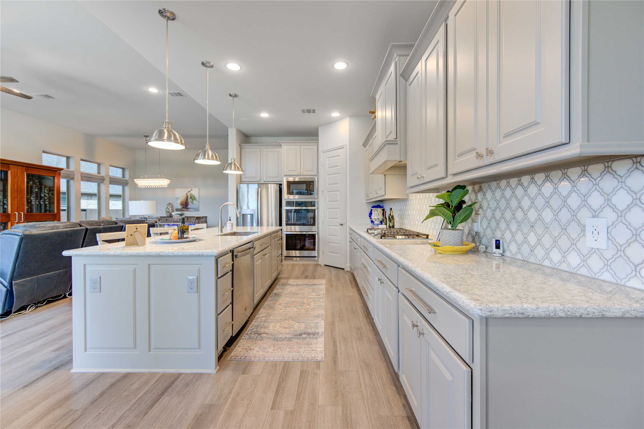 7326 Orangetip Road Katy, TX 77493 - Photo 13 of 43 The kitchen seamlessly flows into the breakfast nook and living area, creating an inviting open-concept space ideal for gatherings. Whether you're hosting a dinner party or enjoying a quiet morning coffee with a view, this kitchen is the perfect blend of style and efficiency.