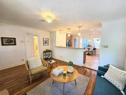 a living room with furniture and wooden floor