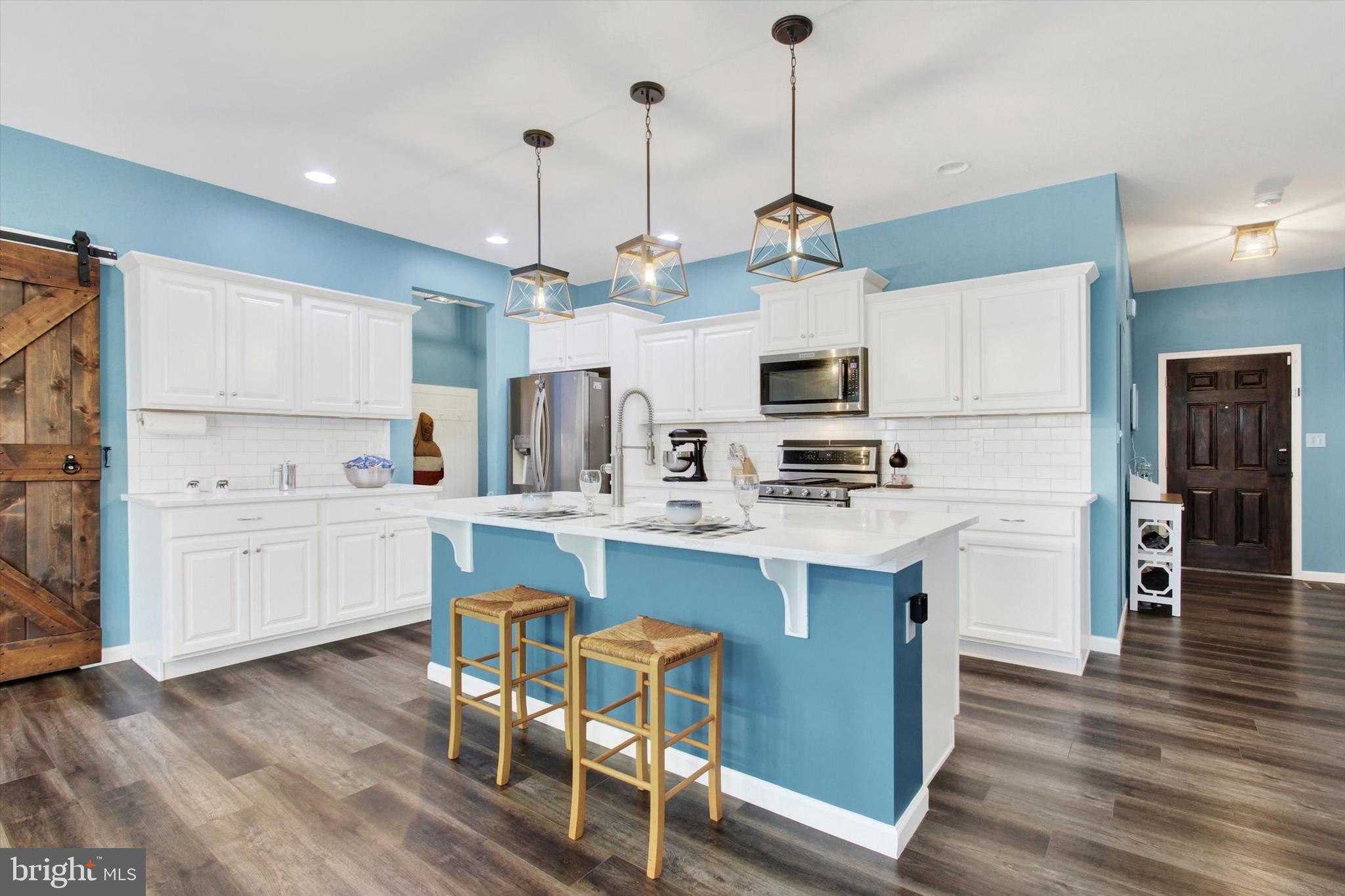 155 Sunbury Way Red Lion, PA 17356 - Photo 2 of 36 a kitchen with kitchen island granite countertop a sink a counter top space stainless steel appliances and cabinets