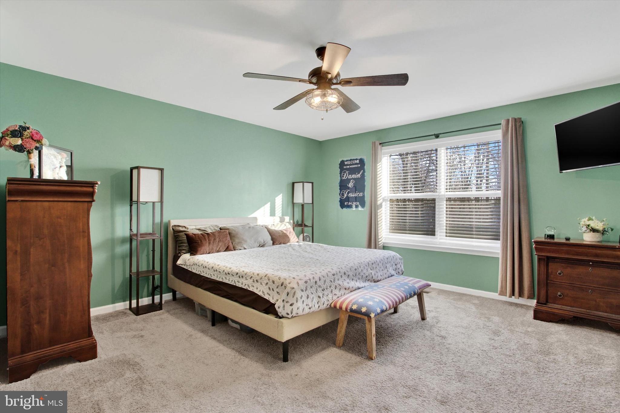 155 Sunbury Way Red Lion, PA 17356 - Photo 24 of 36 a bedroom with a bed and a flat tv screen on dresser