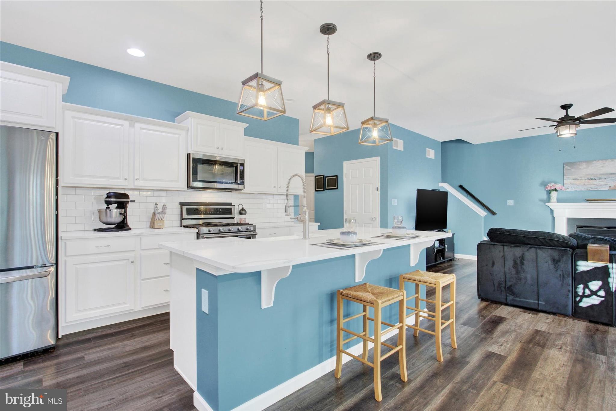 155 Sunbury Way Red Lion, PA 17356 - Photo 7 of 36 a kitchen with stainless steel appliances granite countertop a stove a refrigerator a oven a sink a dining table and chairs with wooden floor