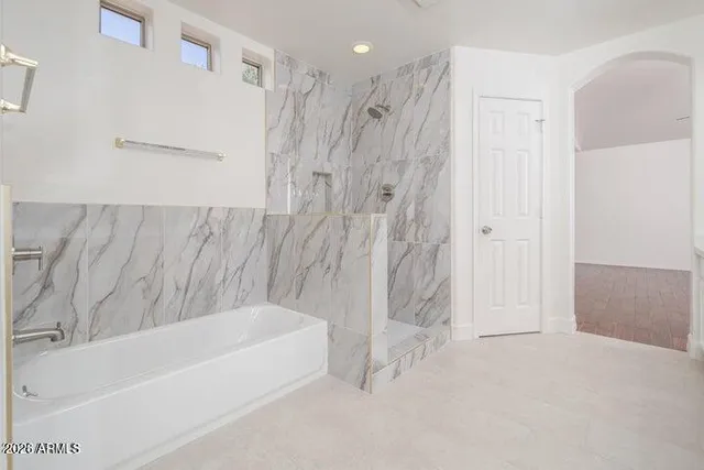 a bathroom with a bathtub and a shower