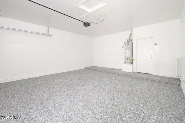 an empty room with a ceiling fan and window