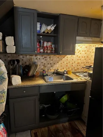a kitchen with a sink and cabinets