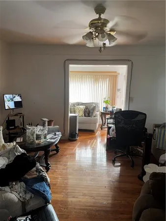 a living room with furniture and a chandelier