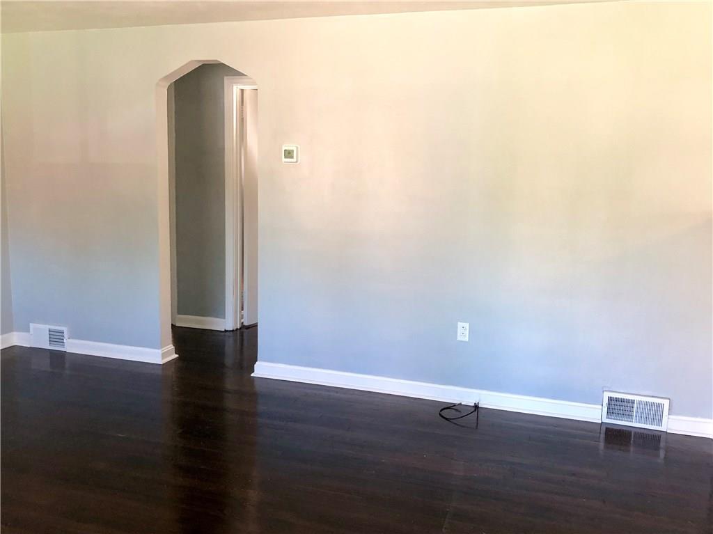 1040 5th Street Baden, PA 15005 - Photo 15 of 25 an empty room with wooden floor and windows