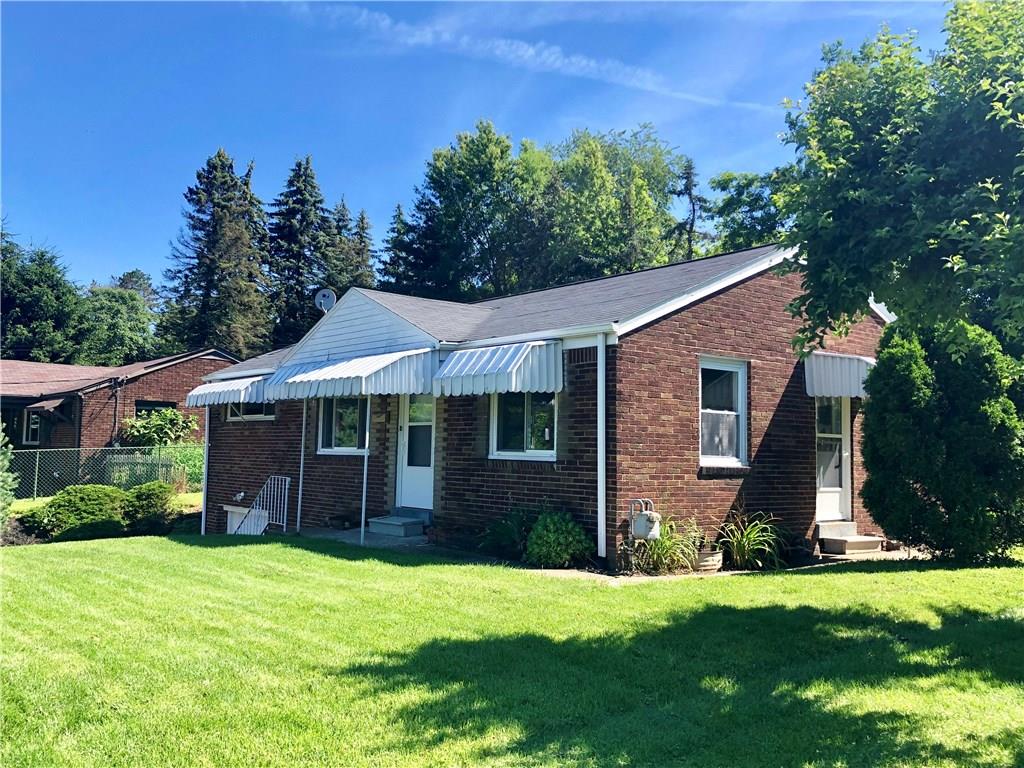 1040 5th Street Baden, PA 15005 - Photo 2 of 25 a front view of a house with a garden