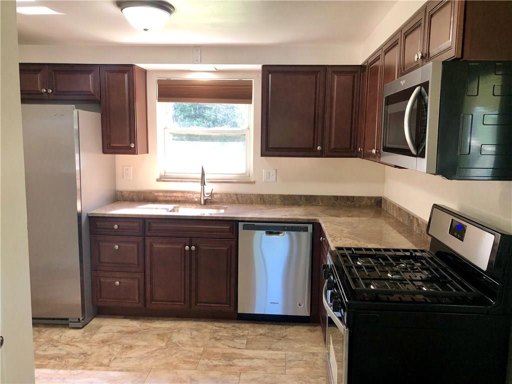 1040 5th Street Baden, PA 15005 - Photo 7 of 25 a kitchen with a sink stove and cabinets