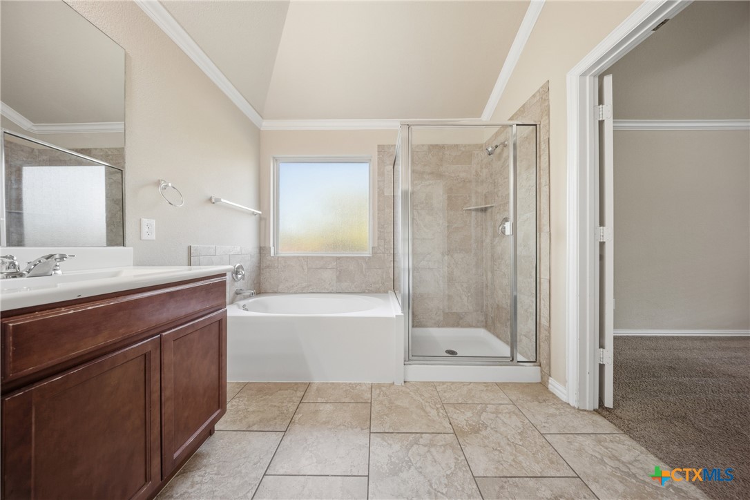 728 Olaf Drive Temple, TX 76504 - Photo 14 of 26 a bathroom with a bathtub shower and a sink