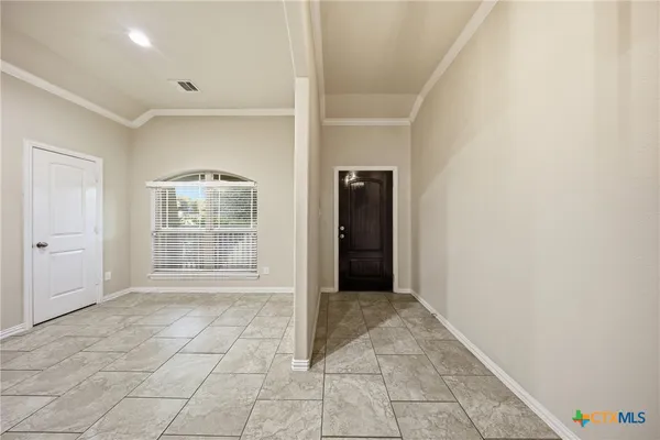 a large kitchen with a stove top oven a sink a counter space and cabinets