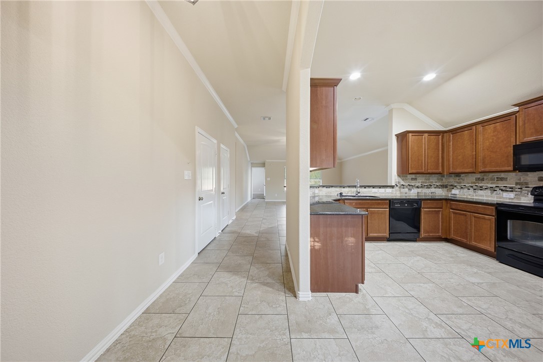 728 Olaf Drive Temple, TX 76504 - Photo 5 of 26 a large kitchen with a stove top oven a sink a counter space and cabinets