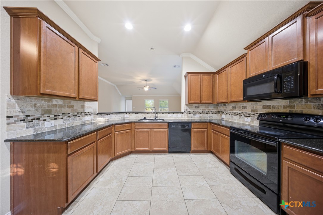 728 Olaf Drive Temple, TX 76504 - Photo 7 of 26 a large kitchen with stainless steel appliances granite countertop a stove granite counter tops and a stove top oven