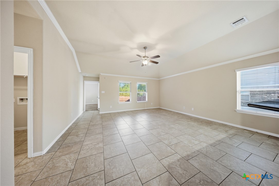 728 Olaf Drive Temple, TX 76504 - Photo 9 of 26 an empty room with windows and chandelier fan