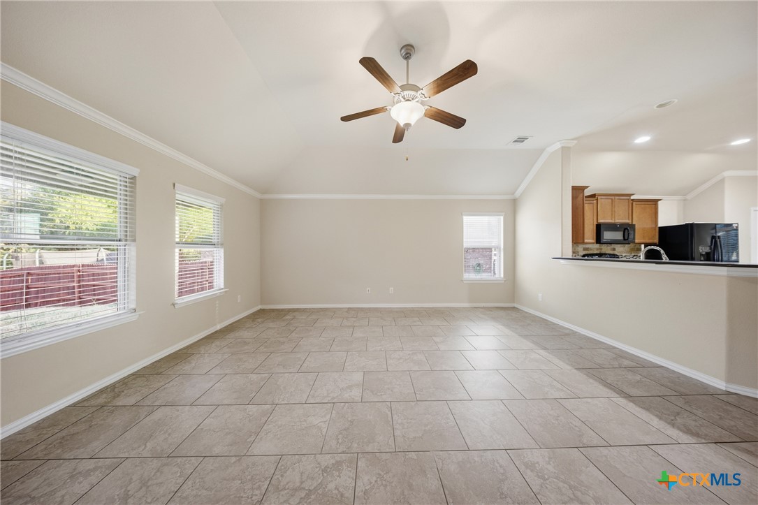 728 Olaf Drive Temple, TX 76504 - Photo 10 of 26 a view of an empty room with kitchen and window