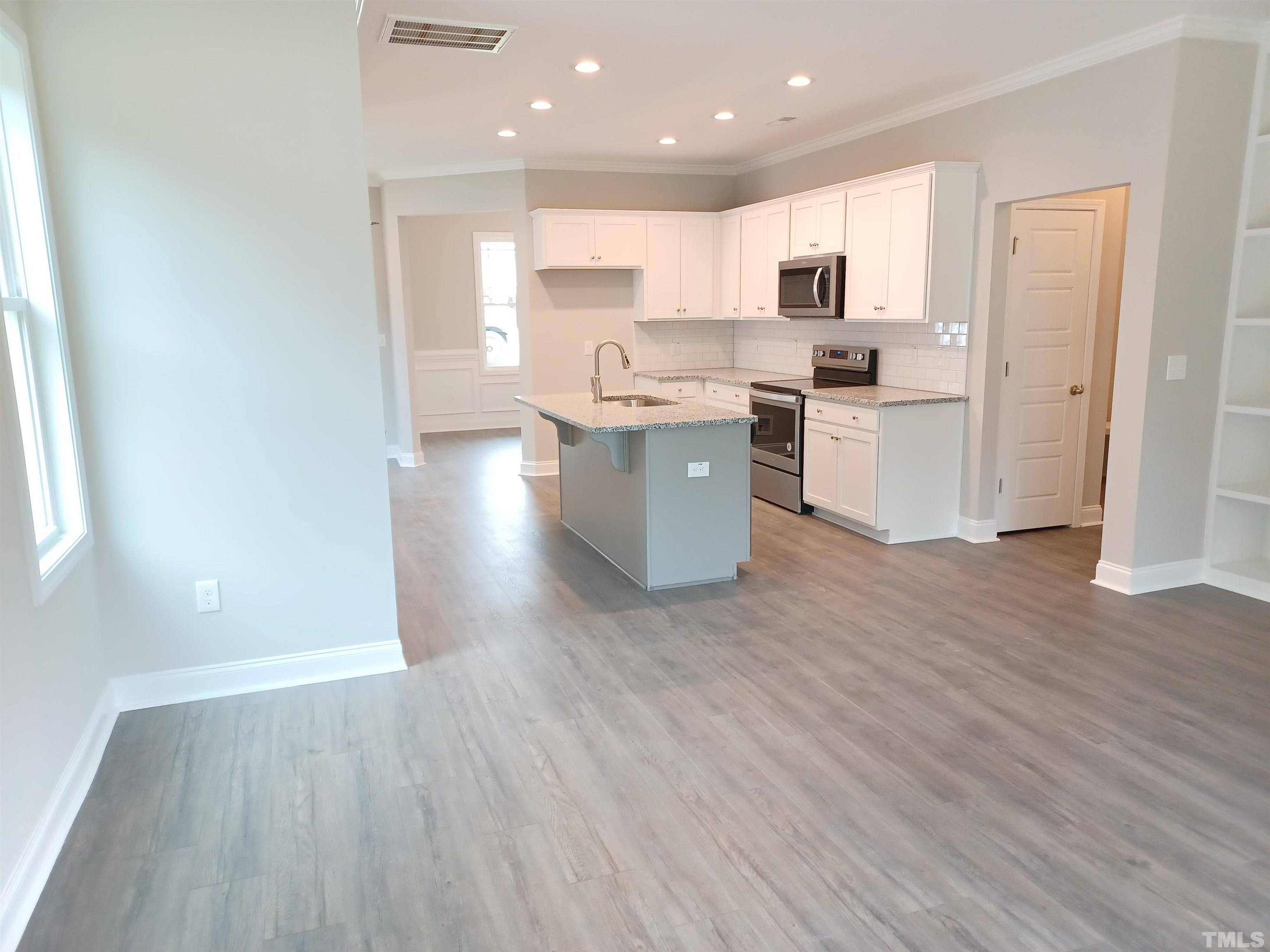 184 Howards Crossing Drive Wendell, NC 27591 - Photo 2 of 27 a kitchen with a refrigerator and a stove top oven