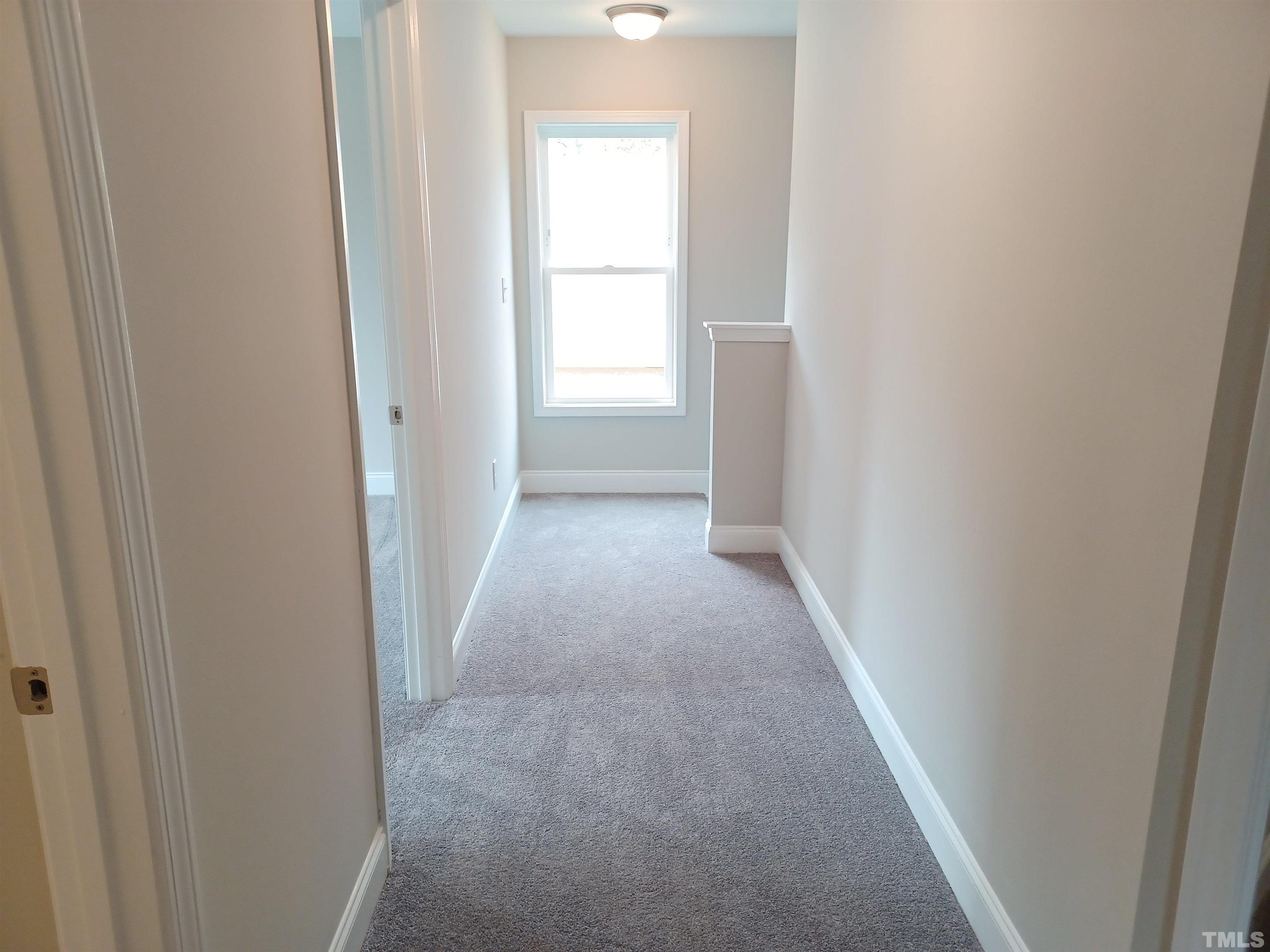 184 Howards Crossing Drive Wendell, NC 27591 - Photo 15 of 27 a view of a hallway with a white walls