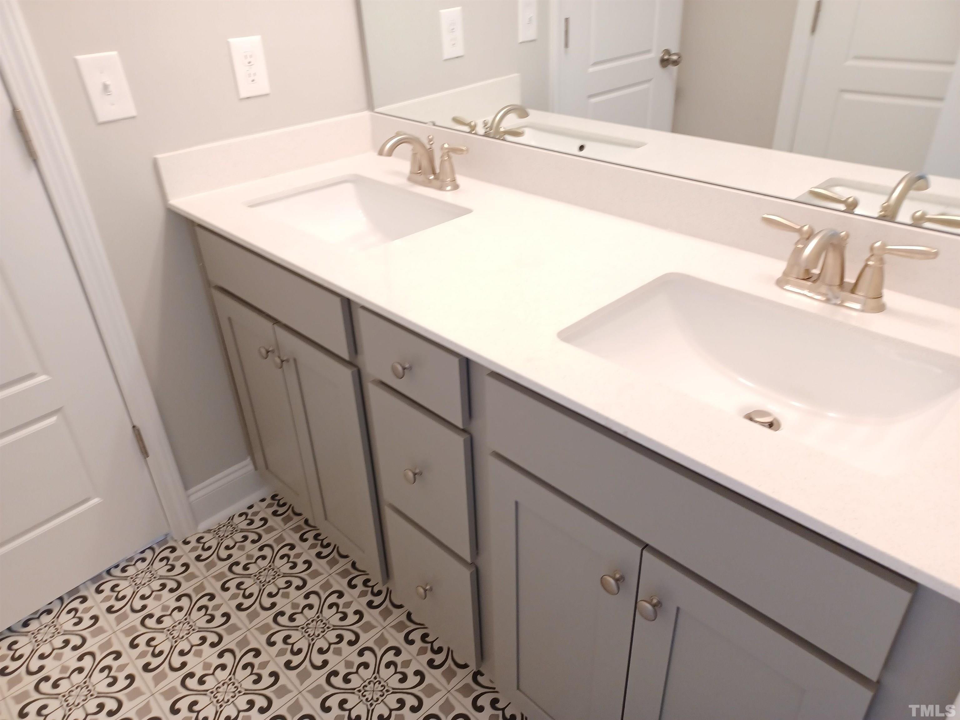 184 Howards Crossing Drive Wendell, NC 27591 - Photo 18 of 27 a bathroom with a sink and a mirror