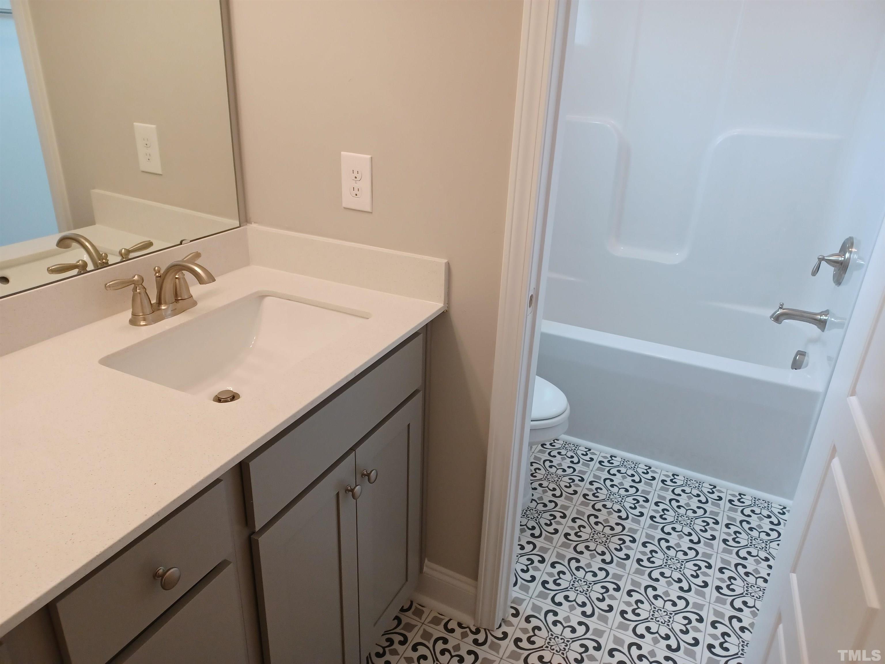 184 Howards Crossing Drive Wendell, NC 27591 - Photo 19 of 27 a bathroom with a sink a toilet and shower
