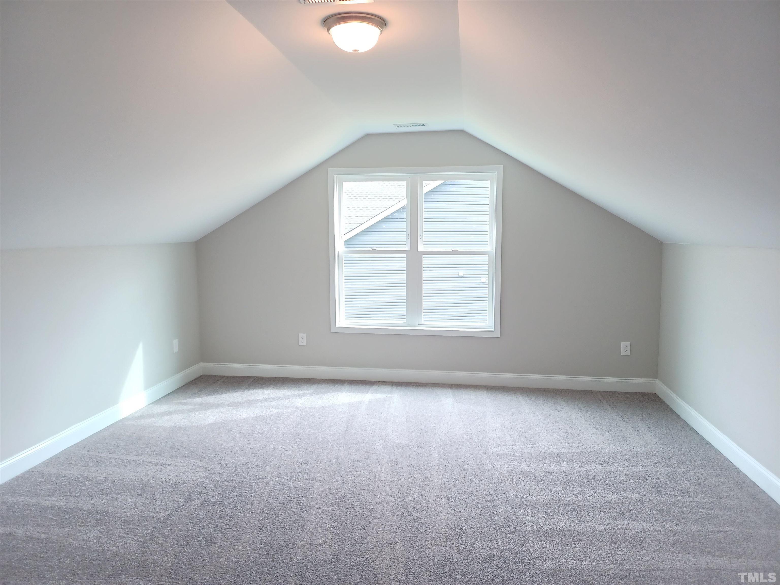184 Howards Crossing Drive Wendell, NC 27591 - Photo 20 of 27 an empty room with wooden floor and windows