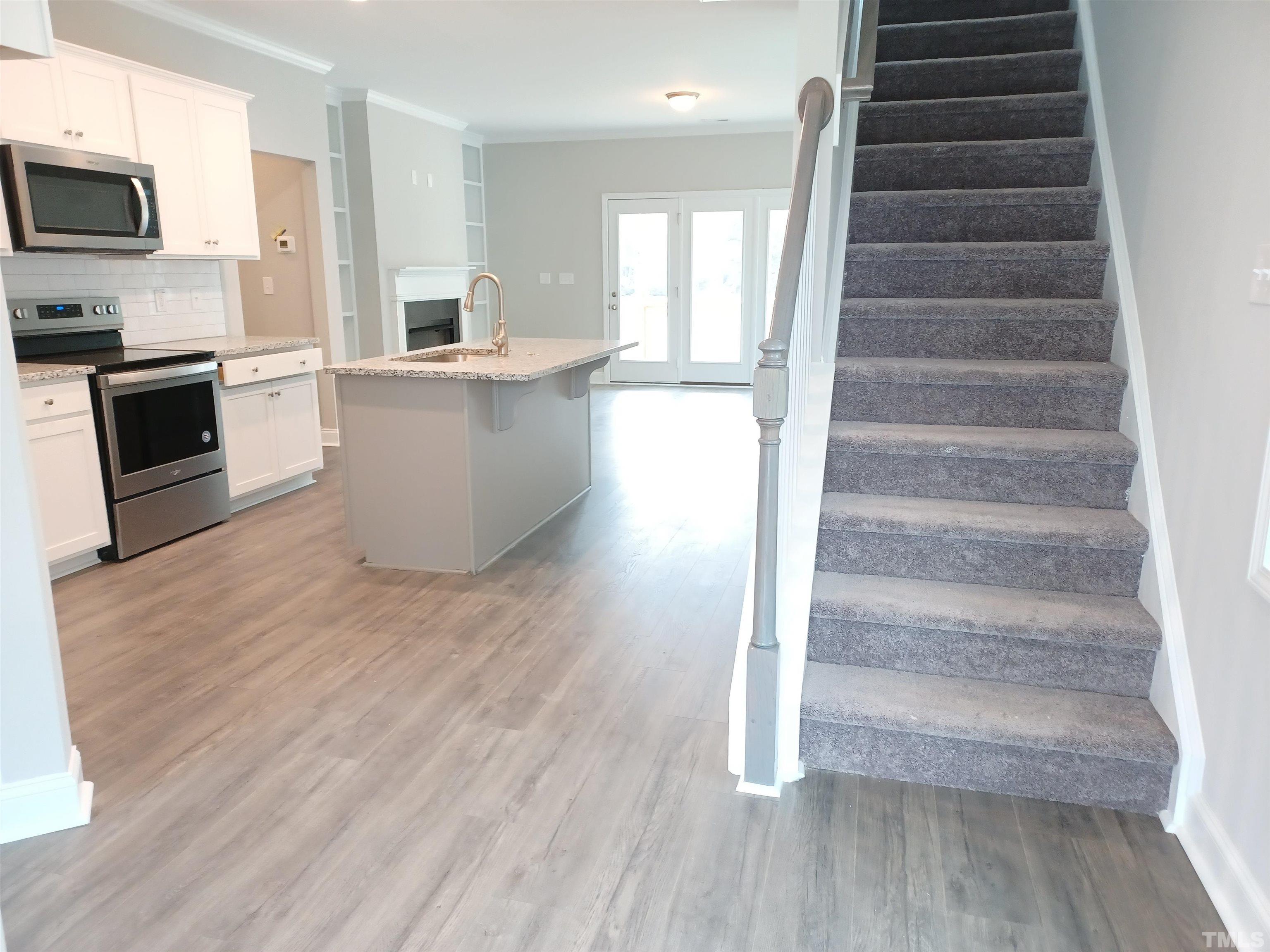 184 Howards Crossing Drive Wendell, NC 27591 - Photo 5 of 27 a view of entryway and kitchen with wooden floor