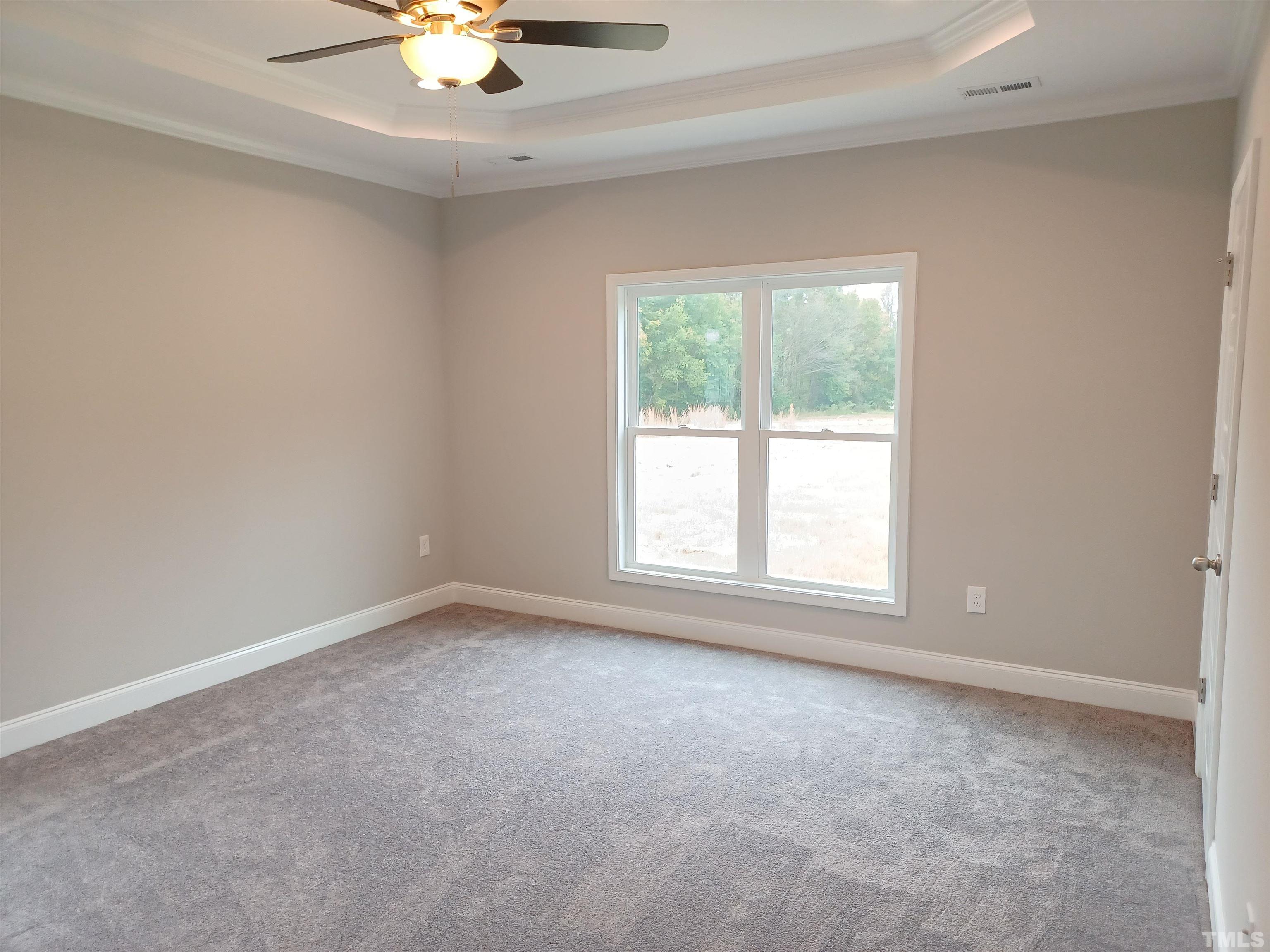 184 Howards Crossing Drive Wendell, NC 27591 - Photo 10 of 27 an empty room with a window and a ceiling fan