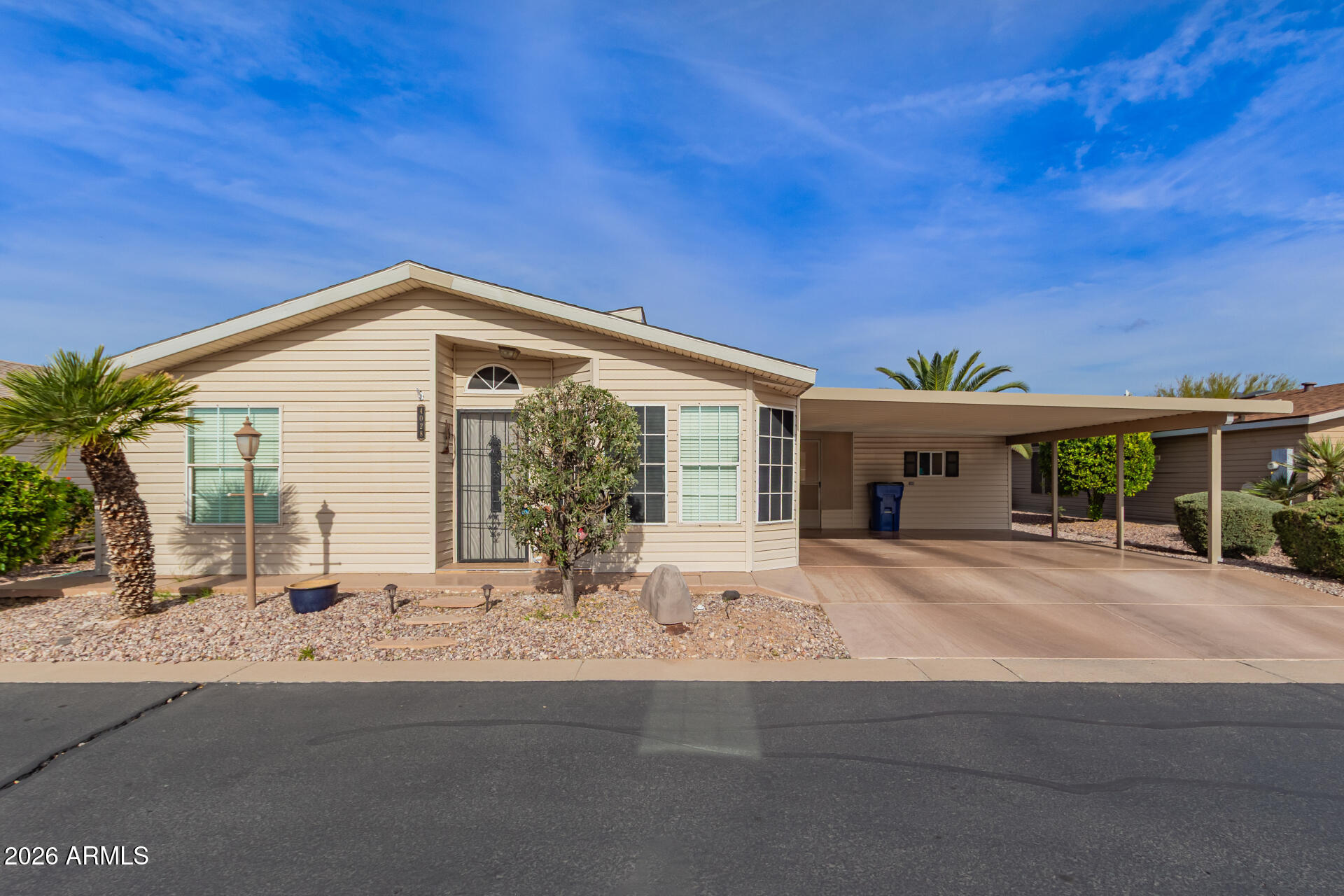 3301 South Goldfield Road, Unit 4028 Apache Junction, AZ 85119 - Photo 12 of 43 a front view of house with yard and seating space