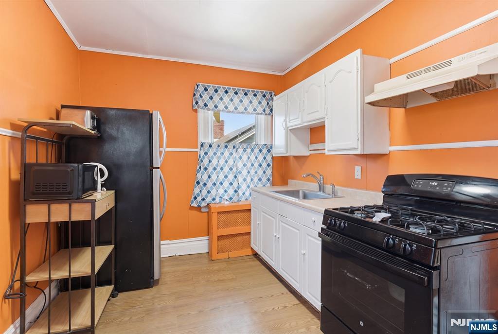 90 Renner Avenue Newark, NJ 07112 - Photo 12 of 25 a kitchen with stainless steel appliances granite countertop a stove and a refrigerator