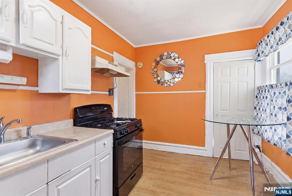 90 Renner Avenue Newark, NJ 07112 - Photo 13 of 25 a kitchen with stainless steel appliances granite countertop a stove a sink and a microwave
