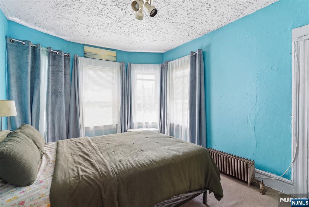 90 Renner Avenue Newark, NJ 07112 - Photo 15 of 25 a bedroom with a bed and a window