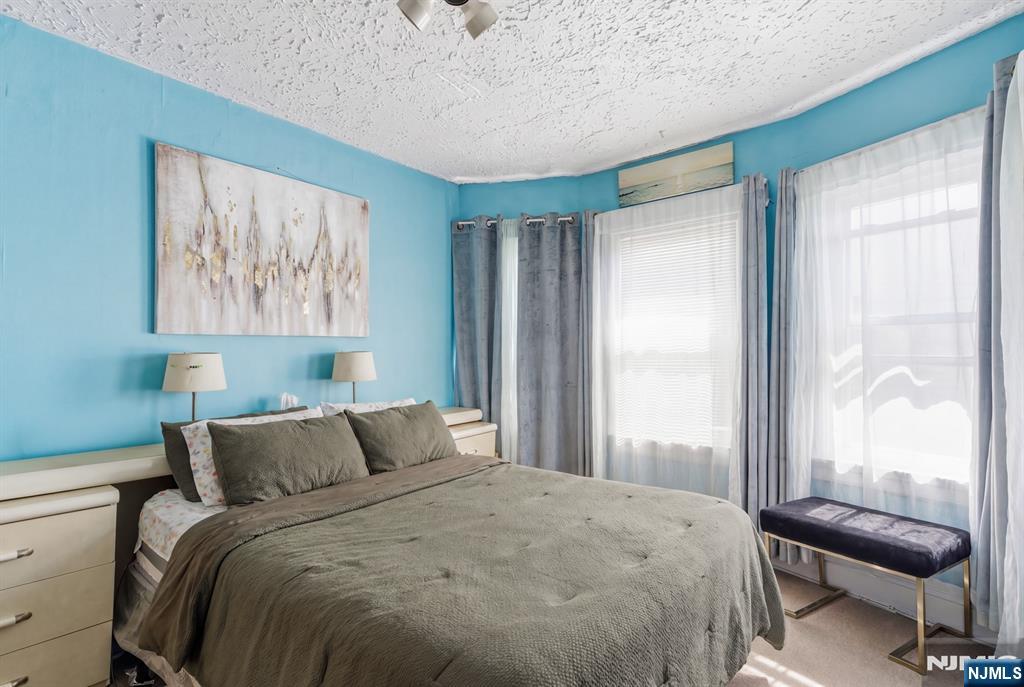 90 Renner Avenue Newark, NJ 07112 - Photo 16 of 25 a bedroom with a bed and a window
