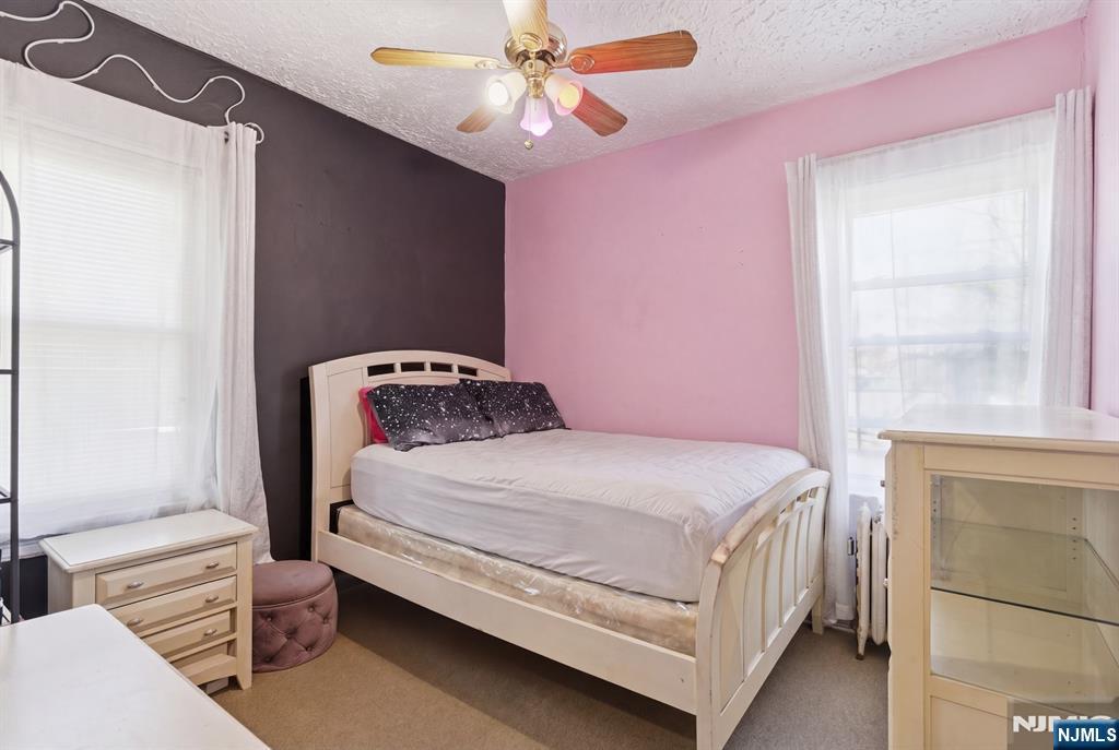 90 Renner Avenue Newark, NJ 07112 - Photo 17 of 25 a bedroom with a bed and a window