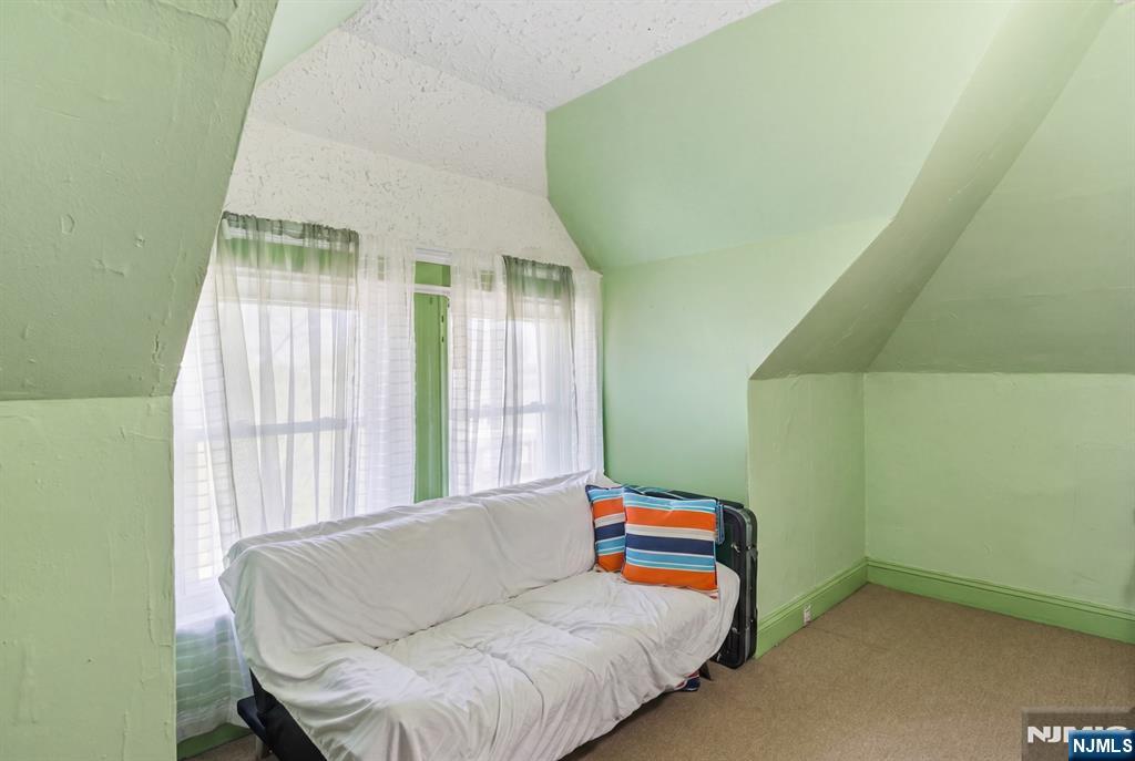 90 Renner Avenue Newark, NJ 07112 - Photo 19 of 25 a bedroom with furniture and a window