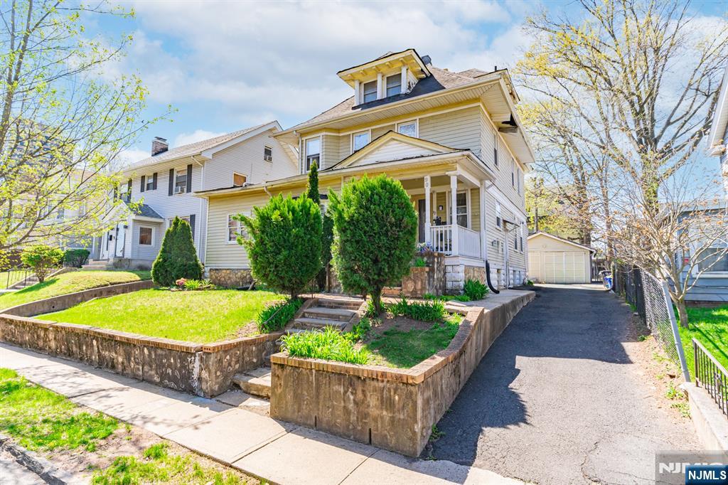 90 Renner Avenue Newark, NJ 07112 - Photo 2 of 25 a front view of a house with a swimming pool