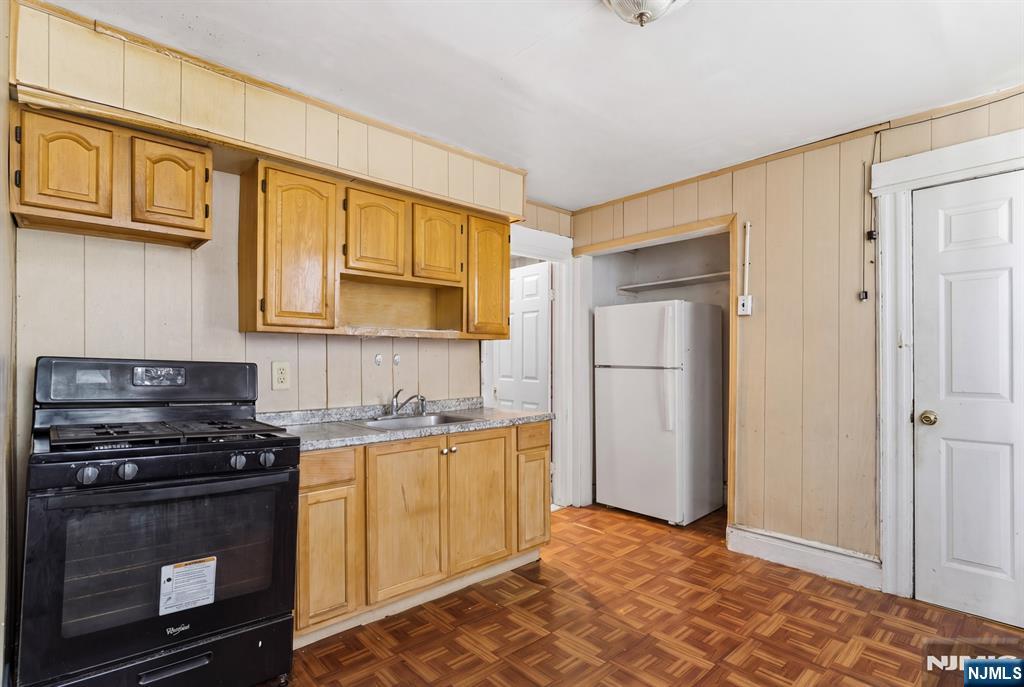 90 Renner Avenue Newark, NJ 07112 - Photo 5 of 25 a kitchen with stainless steel appliances granite countertop a stove a sink and a refrigerator