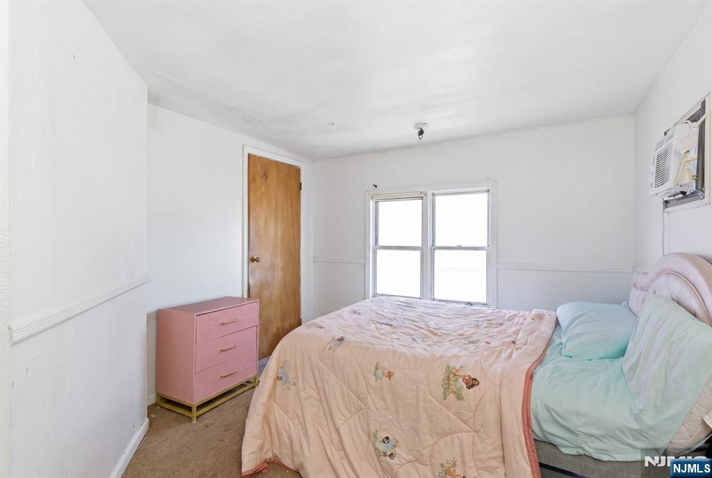 90 Renner Avenue Newark, NJ 07112 - Photo 7 of 25 a bedroom with a bed and wooden floor