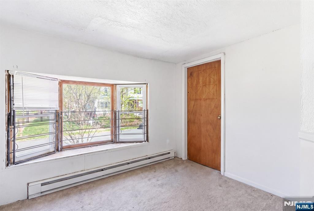 90 Renner Avenue Newark, NJ 07112 - Photo 8 of 25 a view of an empty room with a window