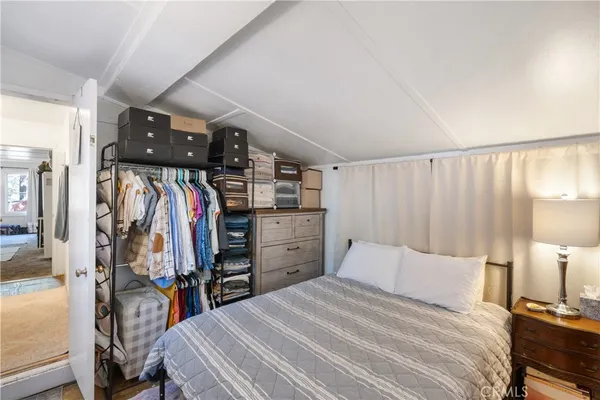 a bedroom with a bed and a walk in closet