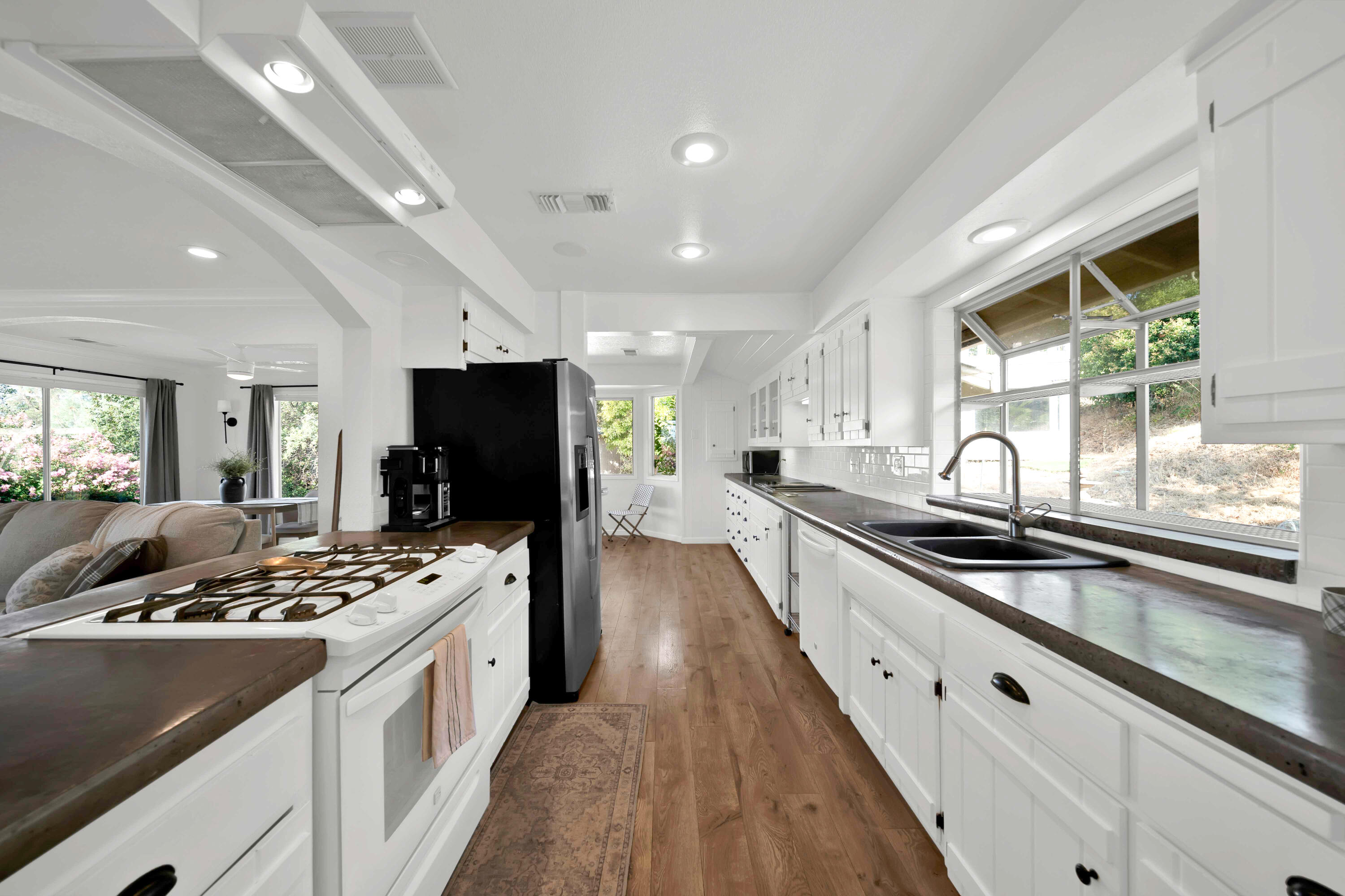 1705 Barbara Road Redding, CA 96003 - Photo 41 of 103 a kitchen with granite countertop a sink stove and cabinets