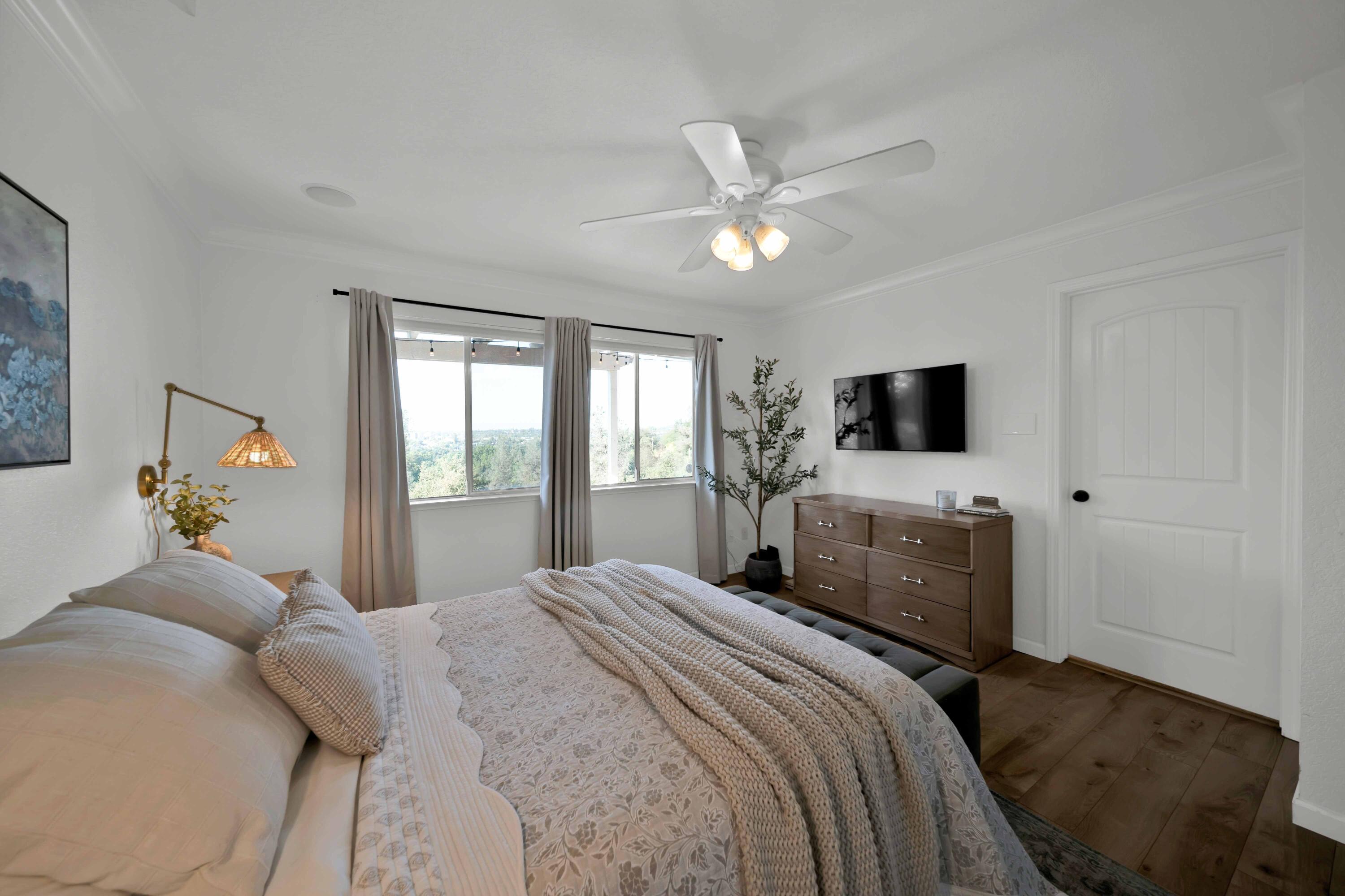 1705 Barbara Road Redding, CA 96003 - Photo 69 of 103 a bedroom with a bed and a flat screen tv